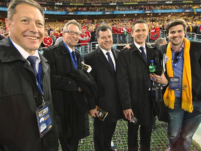 On the job: A sports stadium is often the “office” for Paul Slater (far right). Photo: Paul Slater