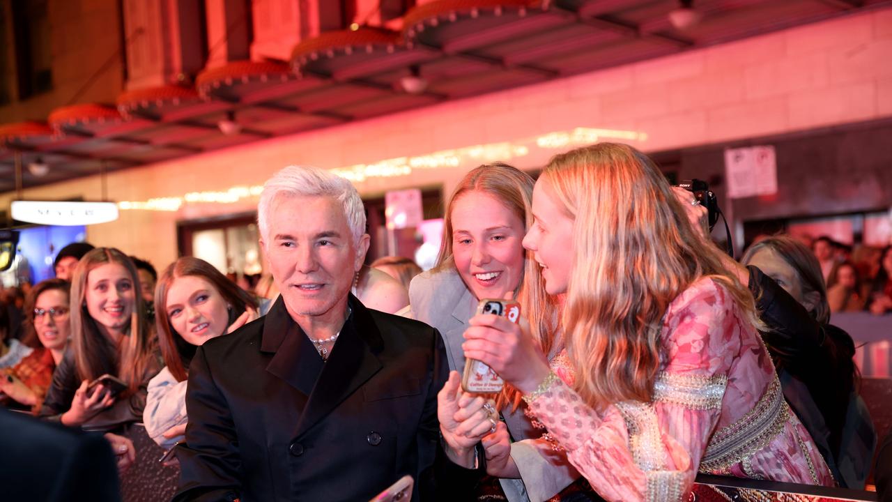 Baz Luhrmann on gets a photo with fans who were also in the movie on the red carpet at the Sydney premiere of Elvis, The State Theatre, Sydney CBD. Picture: Damian Shaw