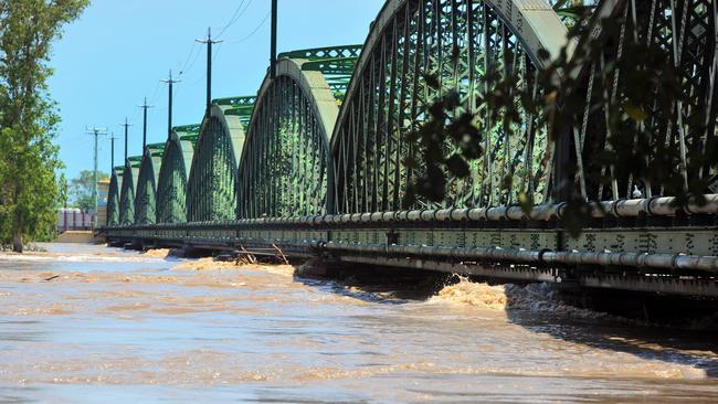 RECORD FLOOD: Bundaberg railway bridge stands strong as the worst floods the town has seen in recorded history test its foundations.<br/>Photo: Max Fleet / NewsMail