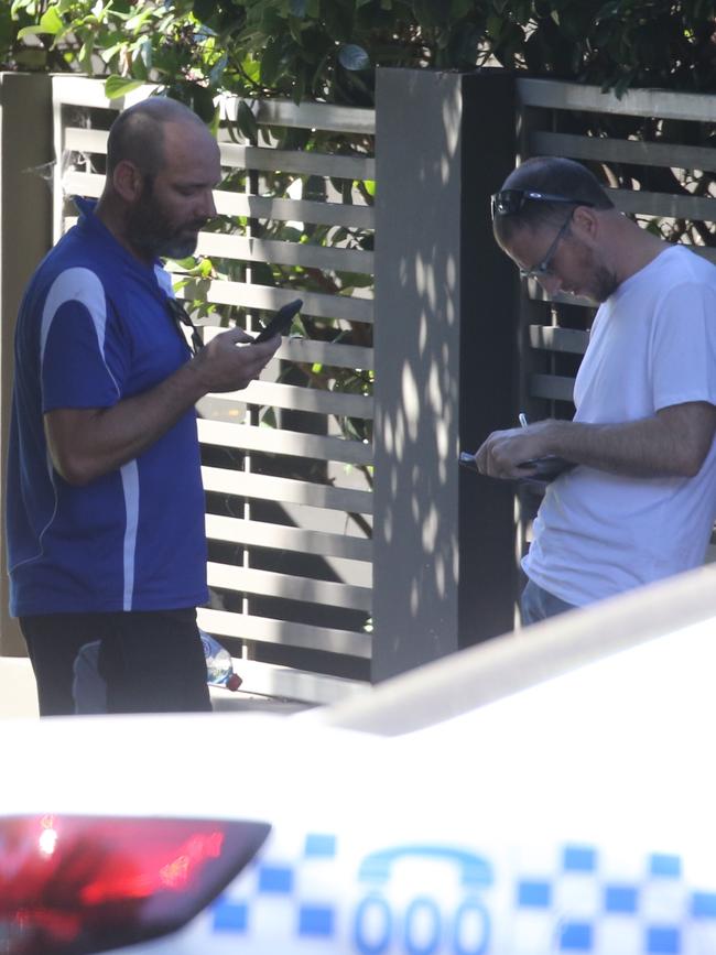 A plain clothed officer speaks to a man outside the mansion. Picture John Grainger