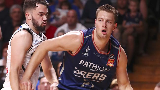 Adelaide’s Daniel Johnson and battles with Melbourne’s Peter Hooley. Picture SARAH REED