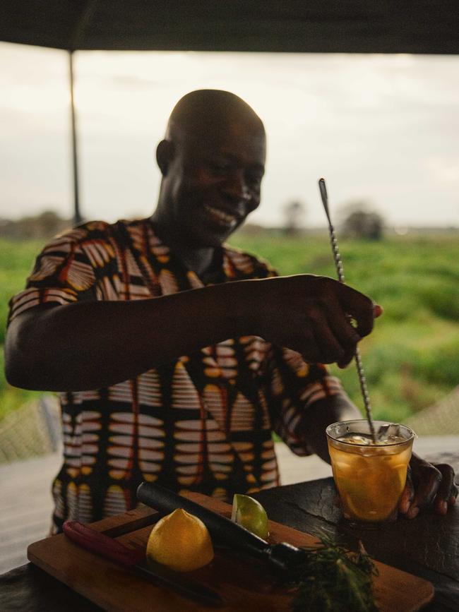 Butler George Oyombe prepares a Dawa cocktail.