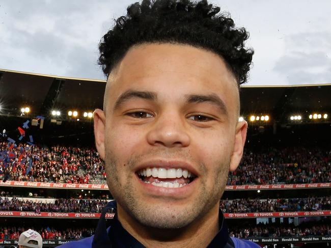 MELBOURNE, VICTORIA - OCTOBER 01: Jason Johannisen of the Bulldogs holds his Norm Smith and Premiership medals after the 2016 AFL Grand Final match between the Sydney Swans and the Western Bulldogs at Melbourne Cricket Ground on October 1, 2016 in Melbourne, Australia. (Photo by Darrian Traynor/AFL Media/Getty Images)