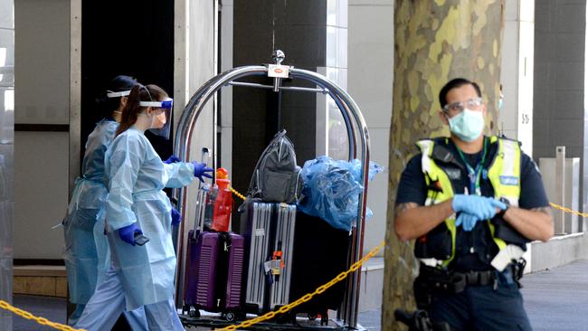 Luggage belonging to quarantined international travellers is loaded onto a coach outside the Holiday Inn on Flinders Lane Picture: NCA NewsWire / Andrew Henshaw