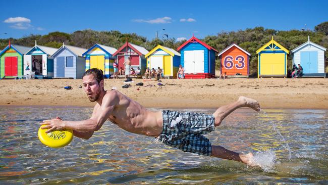 Sam enjoying the sun and sand at Brighton Beach. Life in Melbourne is the second best in the world, according to the latest global liveability survey. Picture: Mark Stewart