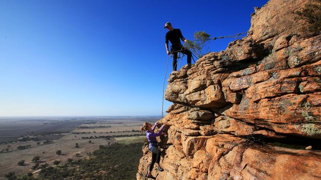 Rock climber Ashlee Hendy makes her way up Mount Arapiles with her boyfriend Christopher Glastonbury in May. Picture: Aaron Francis