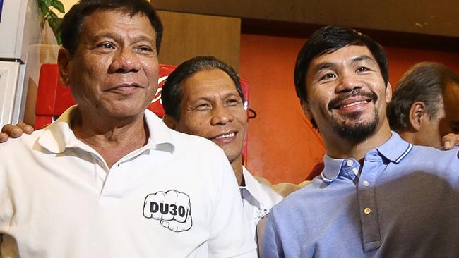 Philippines' President-elect Rodrigo Duterte, left, stands beside boxing icon and newly elected Senator Manny Pacquiao at a meeting in Davao in southern island of Mindanao. Picture: AFP