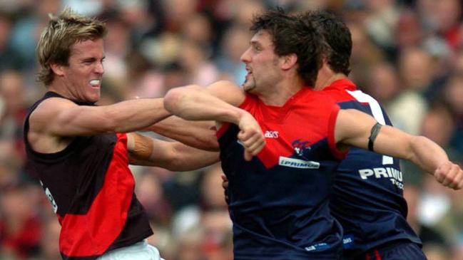 Andrew Welsh clashes with Russell Robertson and Brad Miller during the 2004 elimination final.