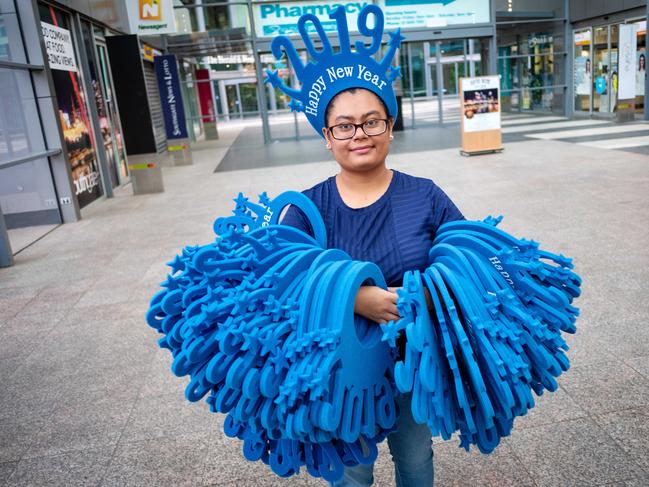 A worker carries New Year’s Eve hats in preparation for revellers in Melbourne. Picture: Mark Stewart