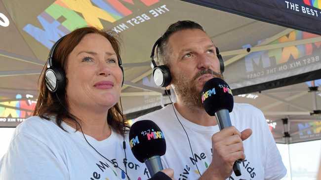 An emotional moment as 92.7 Mix FM breakfast announcers Caroline Hutchinson and Mark Darin discover they have smashed their $600,000 fundraising goal for the Give Me 5 for Kids appeal. Picture: Amber Hooker