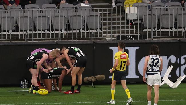 It wasn’t the only drama on the night. Isaac Quaynor of the Magpies collided with a plastic chair on the boundary. Picture: Getty