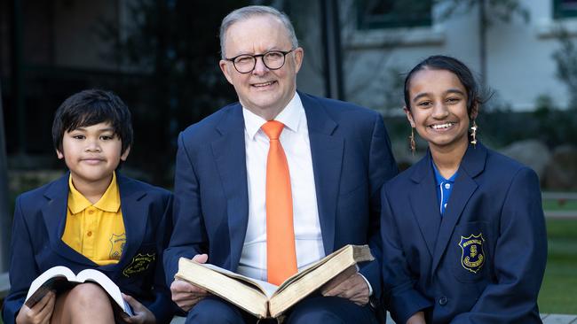 The PM is pictured with past winners of The Premier’s Spelling Bee, Katavu Manu and Alena Kazi. Picture: Julian Andrews