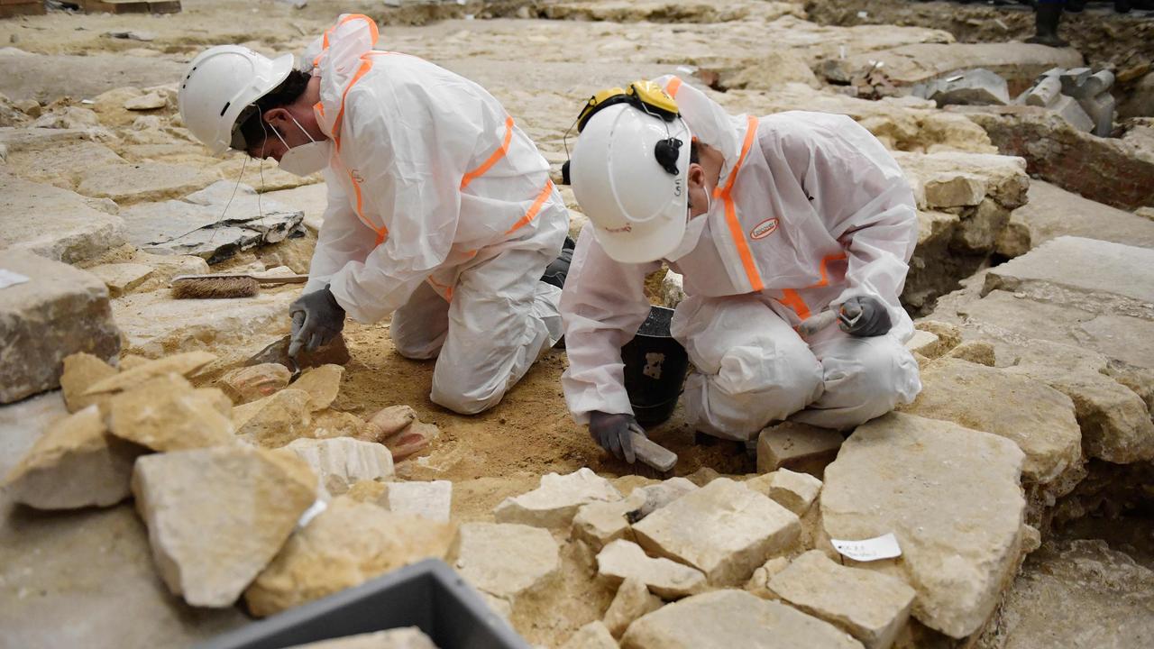 Archaeologists excavate the floor of Notre-Dame cathedral after the discovery of a 14th century lead sarcophagus in Paris. Picture: AFP