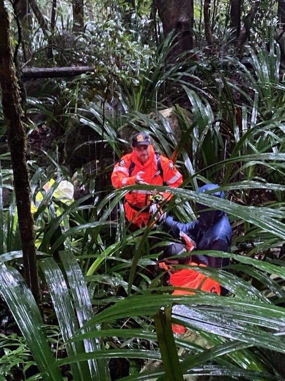 SES crews walk a 23-year-old Parramatta Park woman back to the base of the Bartle Frere track after she became lost. Picture: Queensland Police