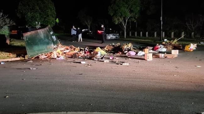 Rubbish strewn over the road after the car hit a skip bin. Picture: Supplied