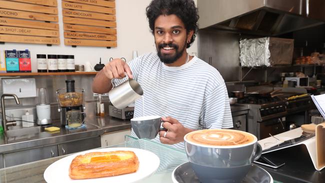 Holy Egg in Southport is one of the cafes open all Easter weekend. Charles Konikkarra at work serving coffees. Picture Glenn Hampson