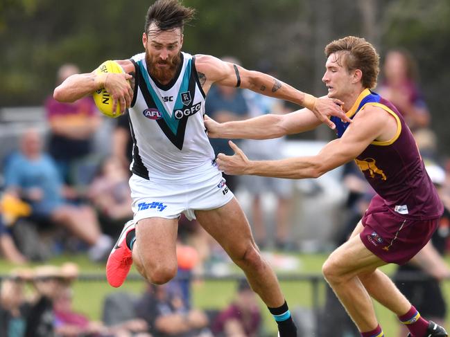 Charlie Dixon (left) of the Power is tackled by Harris Andrews (right) of the Lions during the AFL Marsh Community Series pre-season match between the Brisbane Lions and the Port Adelaide Power at the Moreton Bay Central Sports Complex in Burpengary, Queensland, Sunday, February 23, 2020. (AAP Image/Darren England) NO ARCHIVING, EDITORIAL USE ONLY