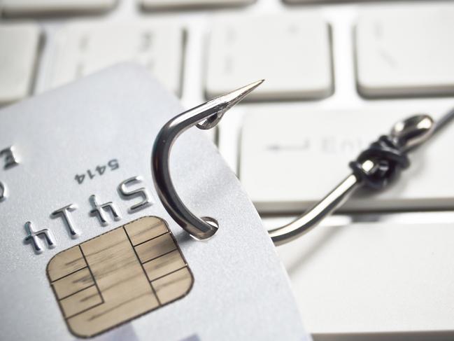 phishing - fish hook with a credit card on white computer keyboard credit card fraud generic, scammers, theft