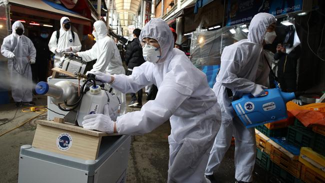 Health workers disinfect a market in Seoul, South Korea. Picture: Chung Sung-Jun/Getty Images