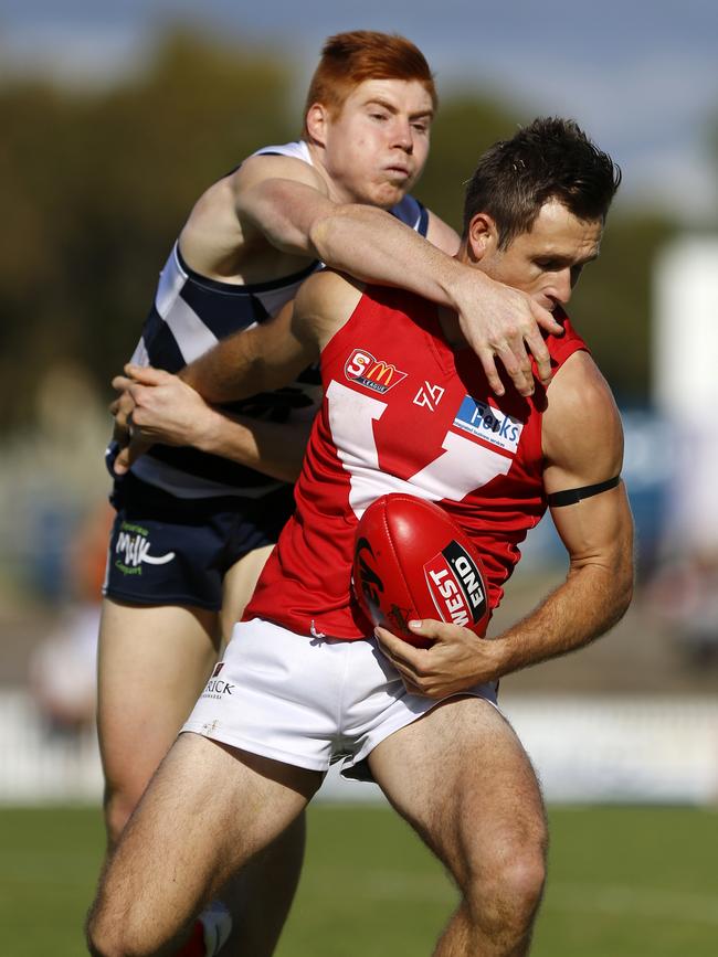 North Adelaide’s Jared Almond holds off South Adelaide’s Joseph Haines. Picture: Deb Curtis