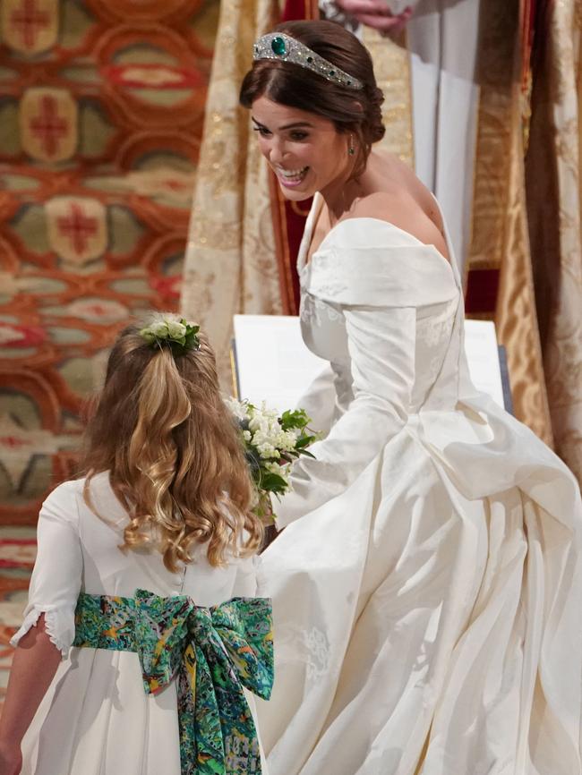 Eugenie passes her bouquet to bridesmaid Savannah Phillips. Picture: Getty