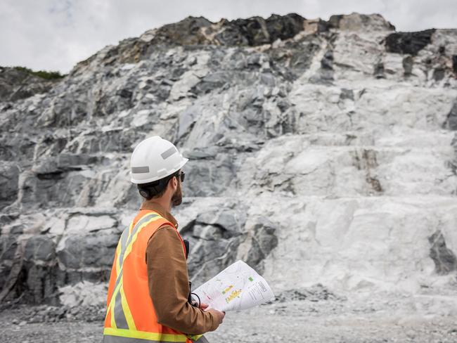 This handout picture provided by Sayona on March 29, 2023 shows an employee of Sayona Quebec in front of a lithium deposit at the company's North American Lithium Complex in La Corne, central Quebec, on July 20, 2022. - As the world races toward emissions-free driving, Canada is making a big push into batteries for electric vehicles -- touting tax incentives, as well as bountiful critical minerals and clean energy to attract multinationals. Its efforts appear to be paying off with companies such as Volkswagen and Stellantis opening plants and more than $18 billion in investment attracted to the sector, which is emerging as second only to top battery manufacturer China. (Photo by Mathieu Dupuis / SAYONA / AFP) / RESTRICTED TO EDITORIAL USE - MANDATORY CREDIT "AFP PHOTO / Sayona / Mathieu DUPUIS / HANDOUT " - NO MARKETING NO ADVERTISING CAMPAIGNS - DISTRIBUTED AS A SERVICE TO CLIENTS