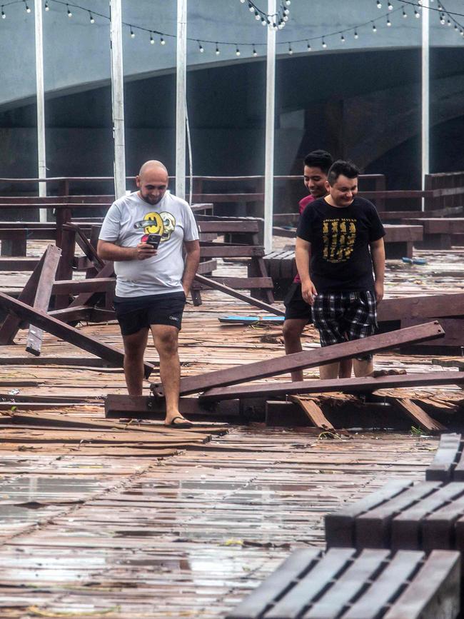 Residents walk along the pier damaged by Hurricane Milton on the coast of Puerto Progeso, Yucatan State, Mexico. Picture: AFP