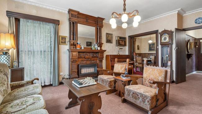 The ornate timber mantel is a feature in the formal lounge room.