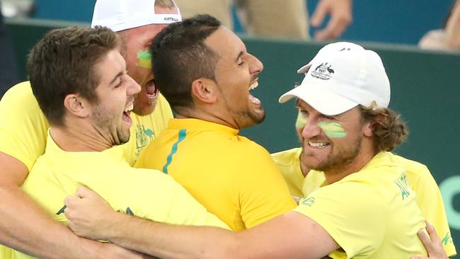 Nick Kyrgios reacts with team mates, to winning the match for Australia.