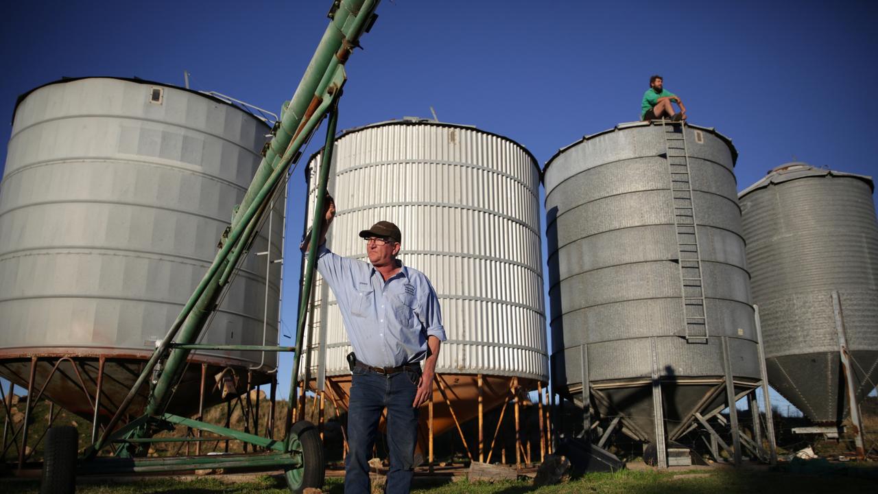 Stuart Hackney and his son Mitchell next to silos that are in the path of the proposed transmission lines on their Dunedoo property. Pic By Dean Marzolla