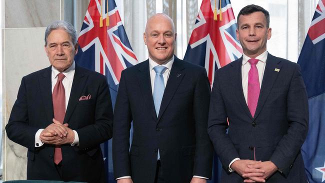 (L-R) Winston Peters, leader of New Zealand First party, New Zealand's incoming Prime Minister Christopher Luxon, and David Seymour, leader of the ACT New Zealand party, attend the signing of an agreement to form a three-party coalition government. Picture: AFP.