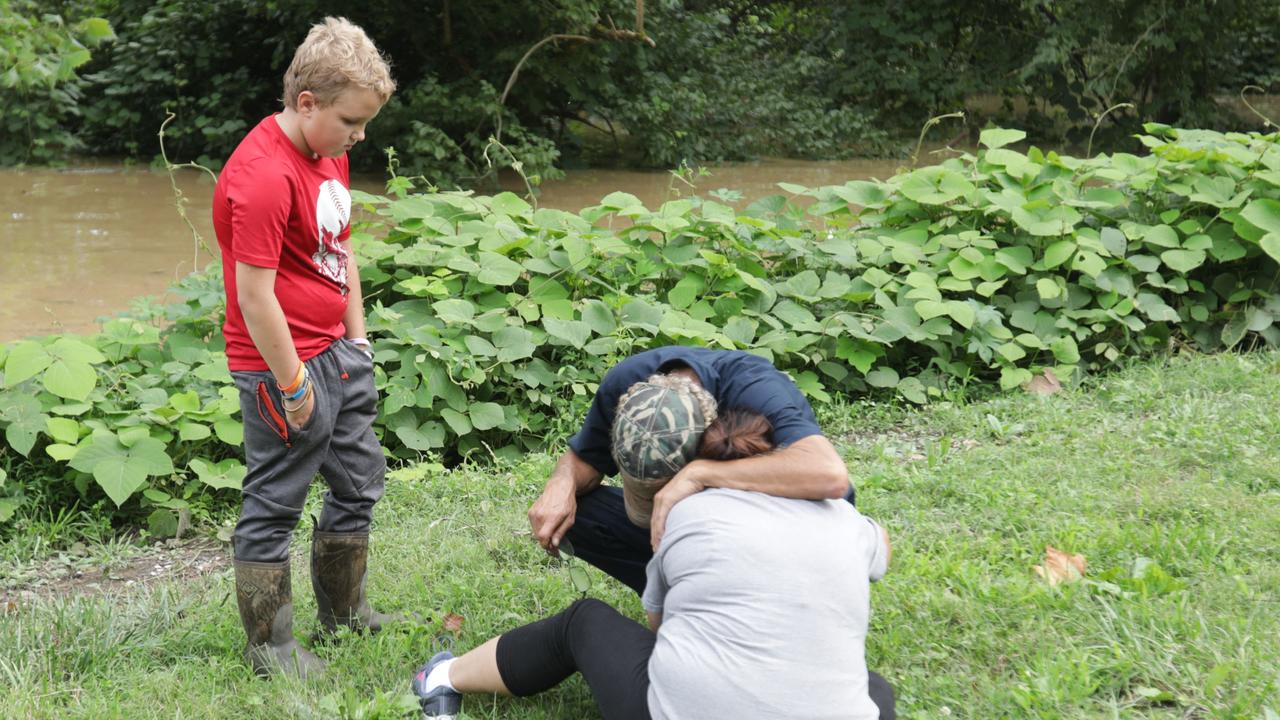 A family anxiously waits to hear about missing family members as a result of the flooding in Jackson. Picture: AFP