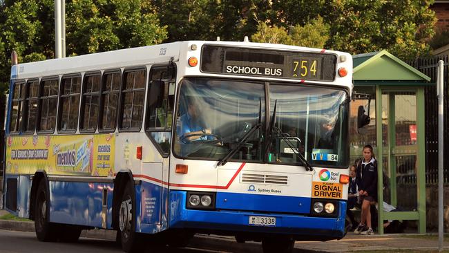 Older buses from Brookvale bus depot pictured on the Northern Beaches. Bus 3338 pictured outside a school.