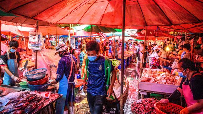 People crowd to buy meat and fish at Khlong Toei wet market despite fears of the spread of the COVID-19 coronavirus in Bangkok. Picture: AFP