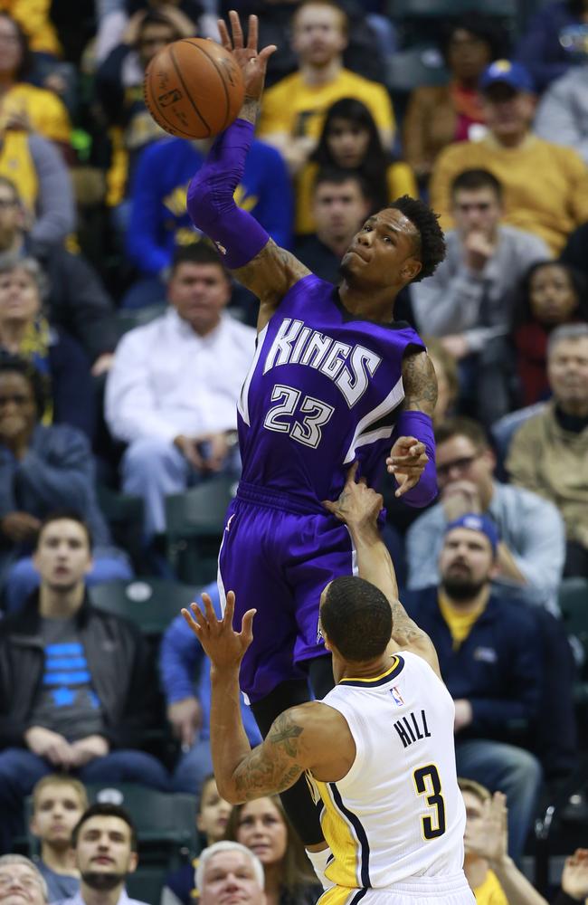 Sacramento Kings guard Ben McLemore (23) tips the basketball back in bounds over Indiana Pacers guard George Hill.