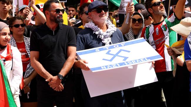 Al Yazbek pictured holding a flag that has a Nazi symbol on it at a protest in Hyde Park. Picture: NewsWire / Damian Shaw Al Yazbek