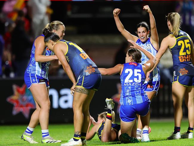 North Melbourne players celebrate a Jasmine Garner goal. Picture: Sarah Reed/AFL Photos via Getty Images