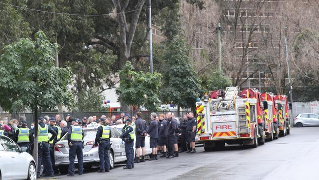 Firefighters and police outside the public housing towers in Melbourne’s inner north. Picture: David Crosling