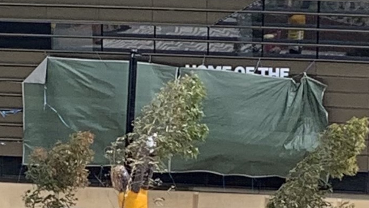 The "Home of the Sydney Roosters" sign is covered up by a $152 Bunnings tarpaulin for Sydney FC’s home match.