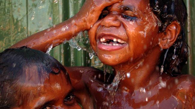 Children wash at Mulan in WA as part of an agreement aimed at tackling trachoma. Picture: Lyndon Mechielsen