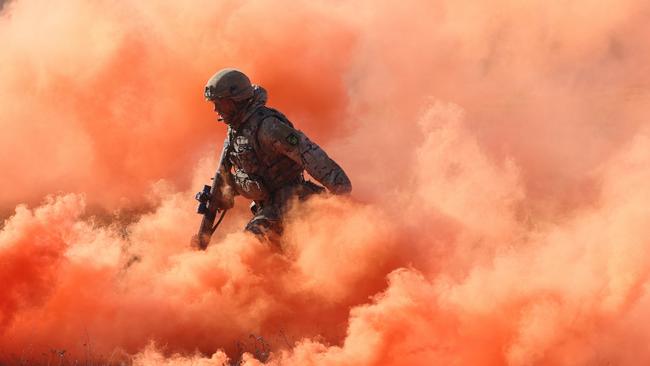 A member Britian’s Royal Anglian infantry storms an enemy position in a simulated attack during a NATO exercises on Sunday in Poland. Picture: Getty Images