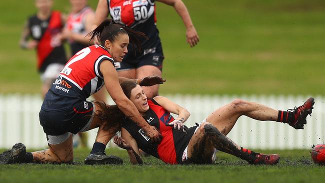 Nicole Callinan battles for the ball against Essendon’s Ruby Svarc.