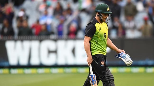 Aaron Finch walks off the field after being dismissed by Bhuvneshwar Kumar. Picture: Getty
