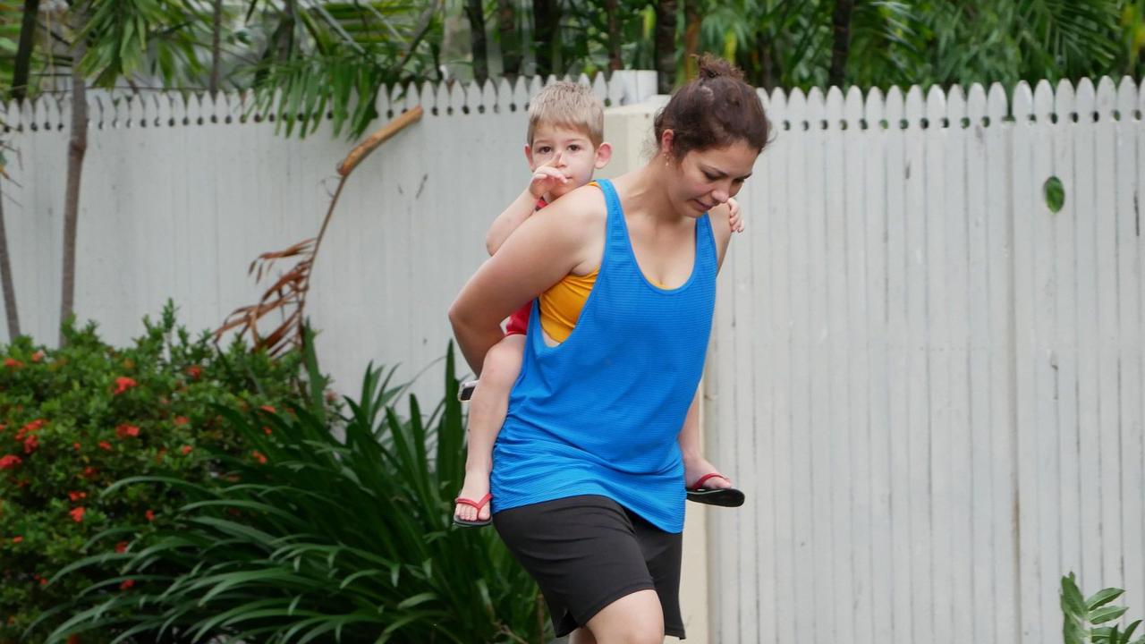 Tropical Cyclone Kirrily 2024: A mother and son survey damage to gardens at houses and the primary school on Potts Street, Belgian Gardens.