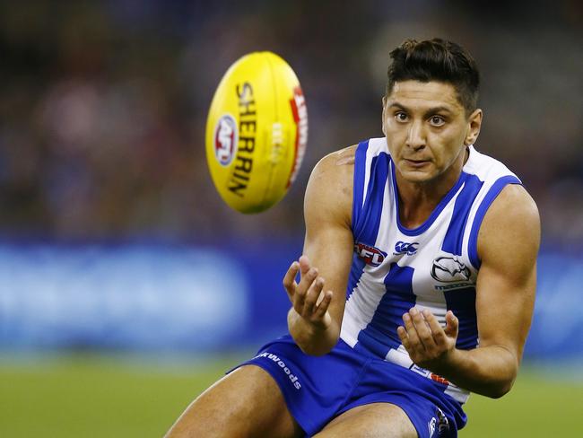 Robin Nahas takes a slidng mark for North Melbourne in 2014.