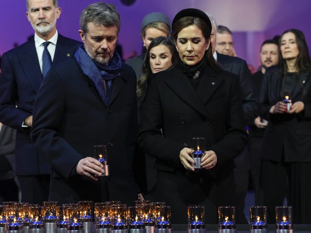 Denmark's King Frederik X and Australian-born Queen Mary place votive candles during the ceremony marking the 80th anniversary of the liberation of Auschwitz in Oswiecim, Poland, on Monday local time. Picture: AP Photo/Czarek Sokolowski