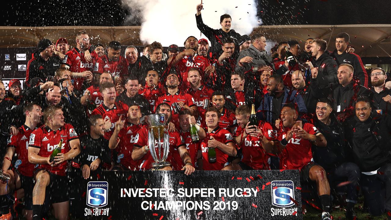 The Crusaders celebrate with the Super Rugby trophy.