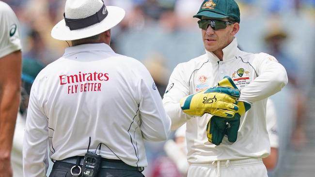 Tim Paine tells Marais Erasmus where he thinks the ball struck Mitchell Santner.