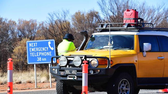 Police check vehicles on the South Australia and Northern Territory border. Calls have been renewed for a tri-state border opening between WA, the NT and South Australia. Picture Chloe Erlich