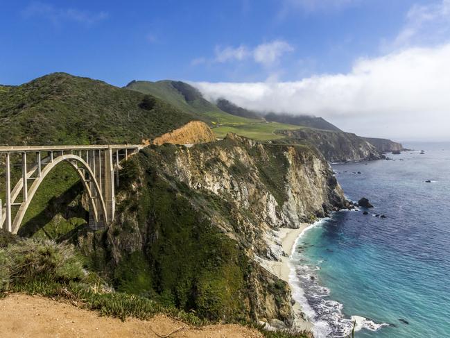 ESCAPE: Richard Dean Anderson - The Bixby Bridge on the Big Sur Coast with fog and the crashing waves of the Pacific Ocean.South of Carmel-by-the-Sea , California. Picture: iStock